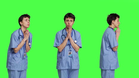 Medical-assistant-being-hopeful-praying-for-good-luck-against-greenscreen